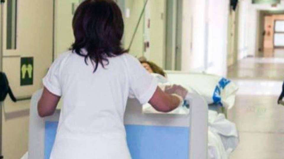 Una trabajadora sanitaria traslada a una paciente en camilla (C.A./ARCHIVO)