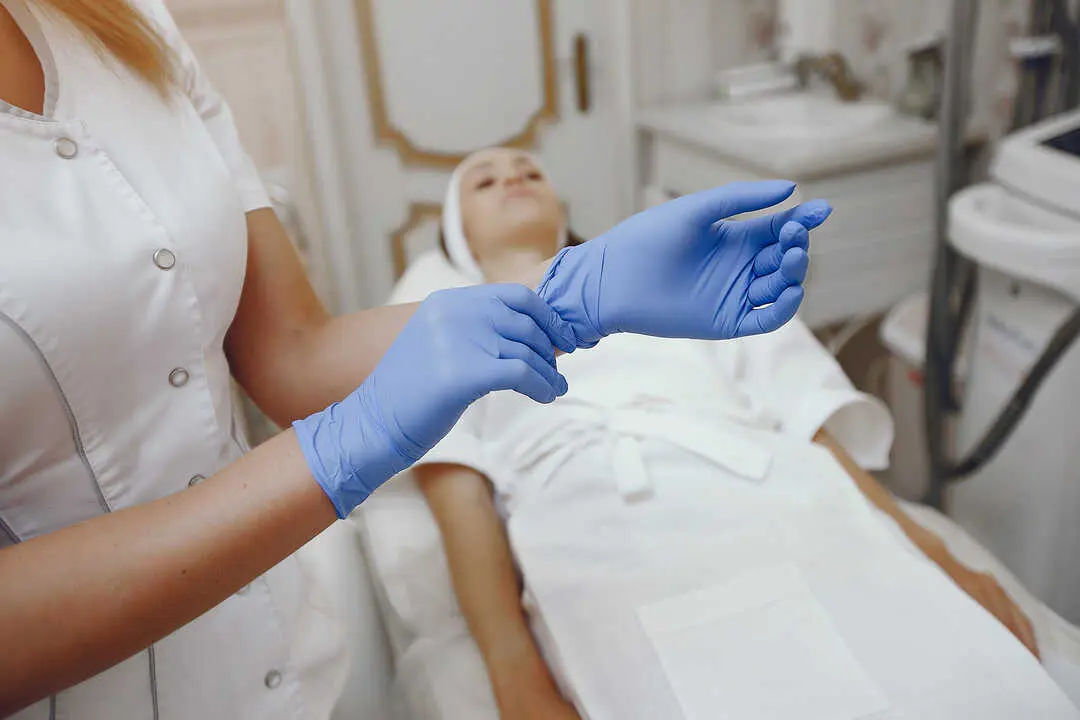 Cosmetologist treats client's skin. Woman with cosmetologist. Lady in a beauty studio.