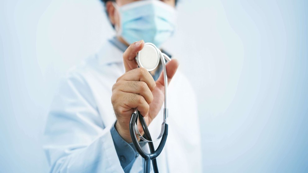Doctor wearing protective mask with stethoscope in hand and, Healthcare and medical concept.                           