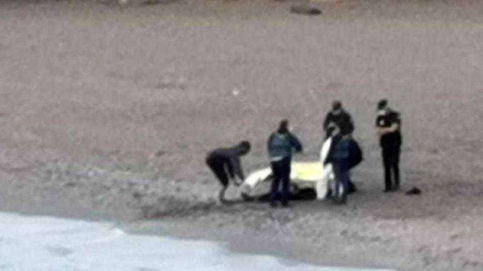 Agentes, junto al cadáver aparecido en la playa (C.A.)