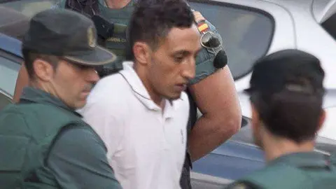 Driss Oukabir, suspected of involvement in the terror cell that carried out twin attacks in Spain, is escorded by Spanish Civil Guards from a detention center in Tres Cantos, near Madrid, on August 22, 2017 before being tranferred to the. National CourtUnder heavy security, police vans entered the National Court, which deals with terrorism cases, where a judge will question them and decide what -- if any -- charges to press against them over the vehicle attacks that left 15 dead and 120 injured. / AFP PHOTO / STRINGER