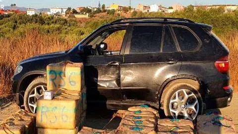 El veh&iacute;culo conducido por los narcos junto a la droga incautada (GUARDIA CIVIL)
